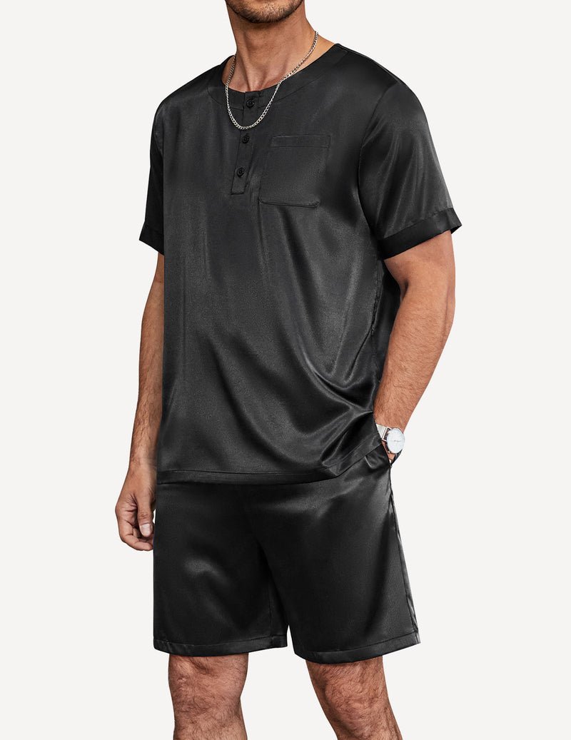 Men's satin pajama set in black: close-up henley top with pocket and elastic waist shorts