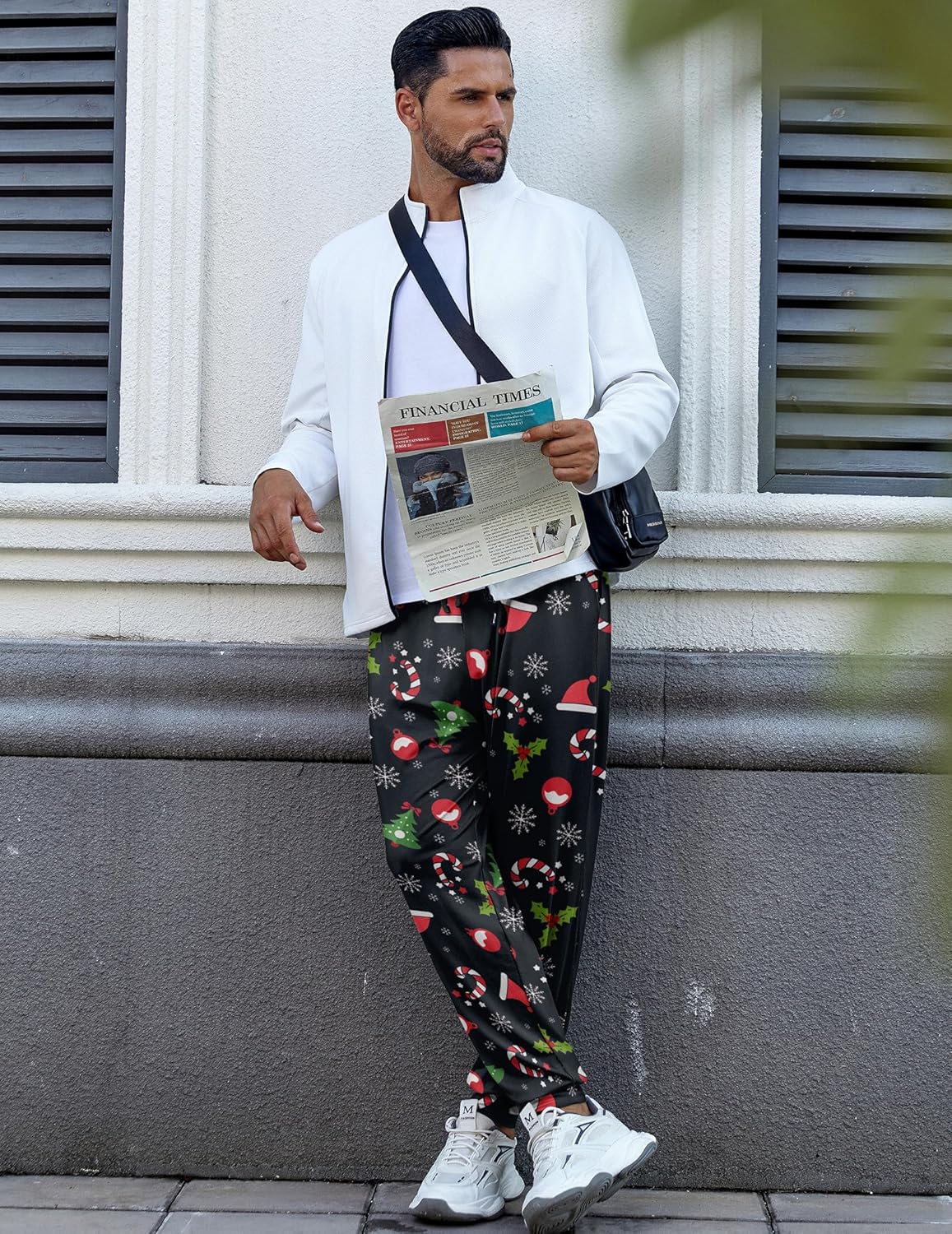 Black Christmas pajama pants with festive red and green pattern, elastic waist