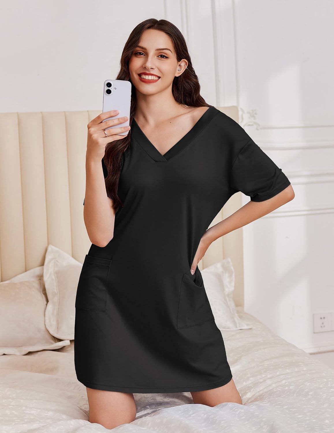 Short-sleeve nightgown, black V-neck with chest pocket; model holds smartphone