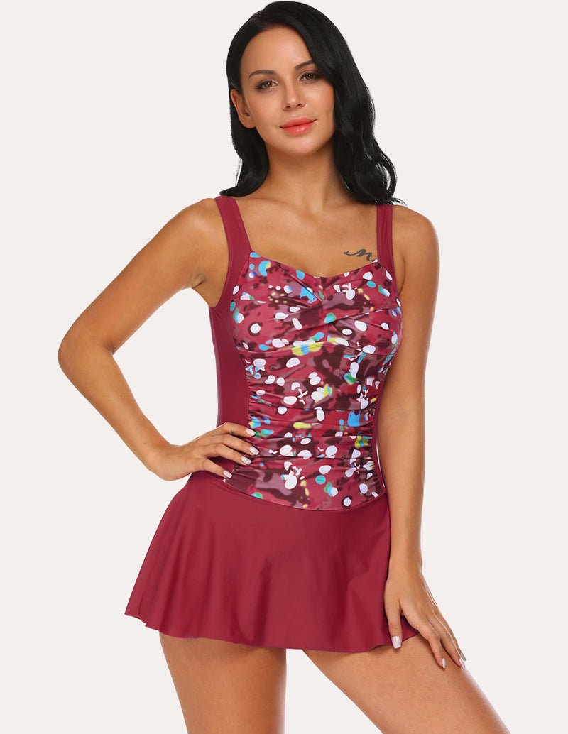 Burgundy one-piece skirted swimsuit with colorful speckled print top and flared skirt