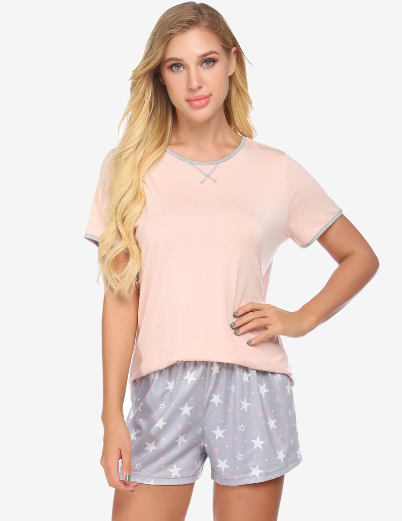 Pink short-sleeve pajama top with contrast trim and grey star-print shorts