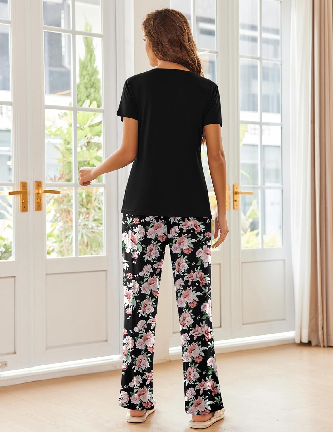 Women's pajama set with black short-sleeve top and pink floral wide-leg pajama pants, back view