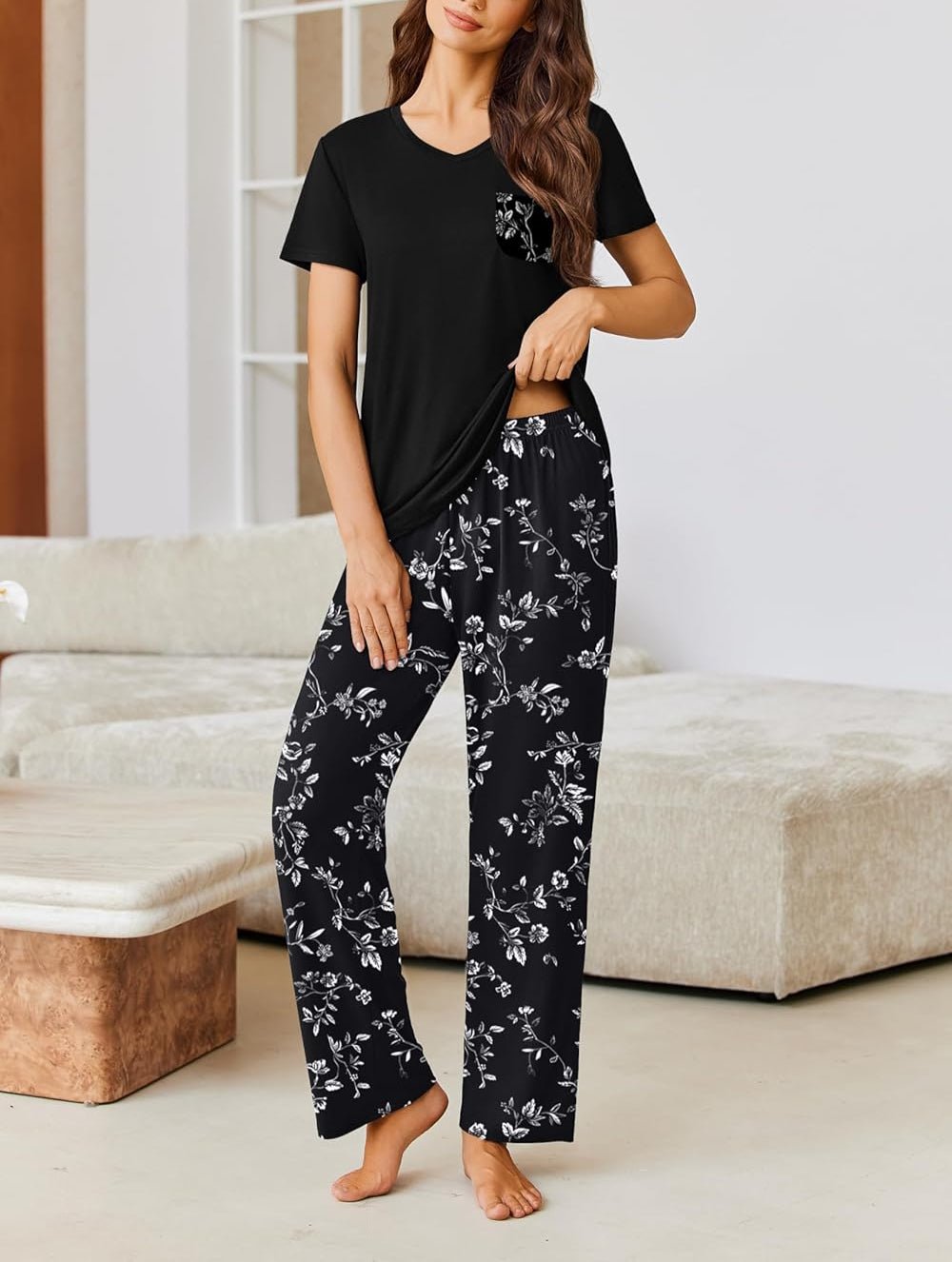 Two-piece pajama set with black short-sleeve top and black floral long pants