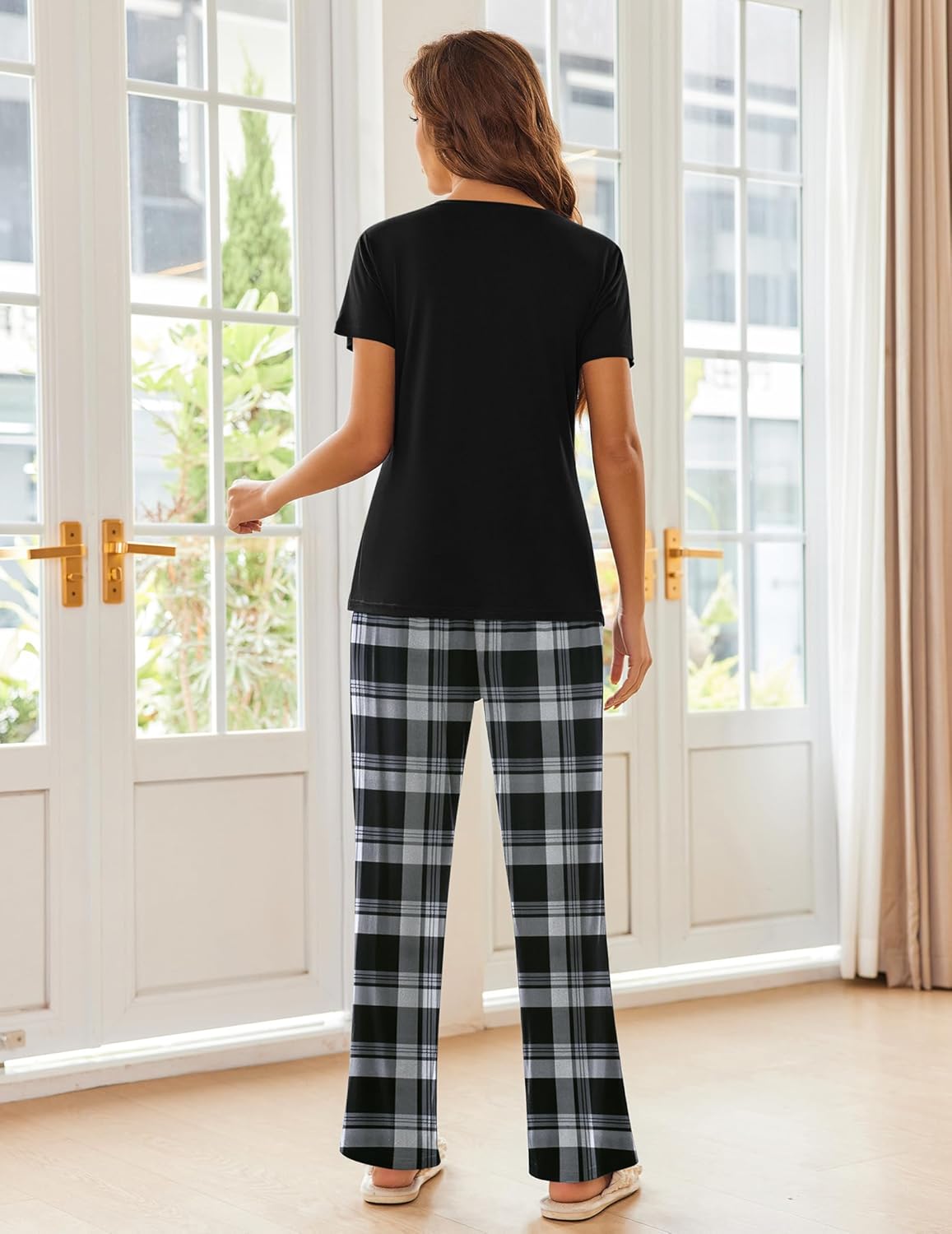 Women's pajama set with black short-sleeve top and black-and-white plaid wide-leg pajama pants, back view