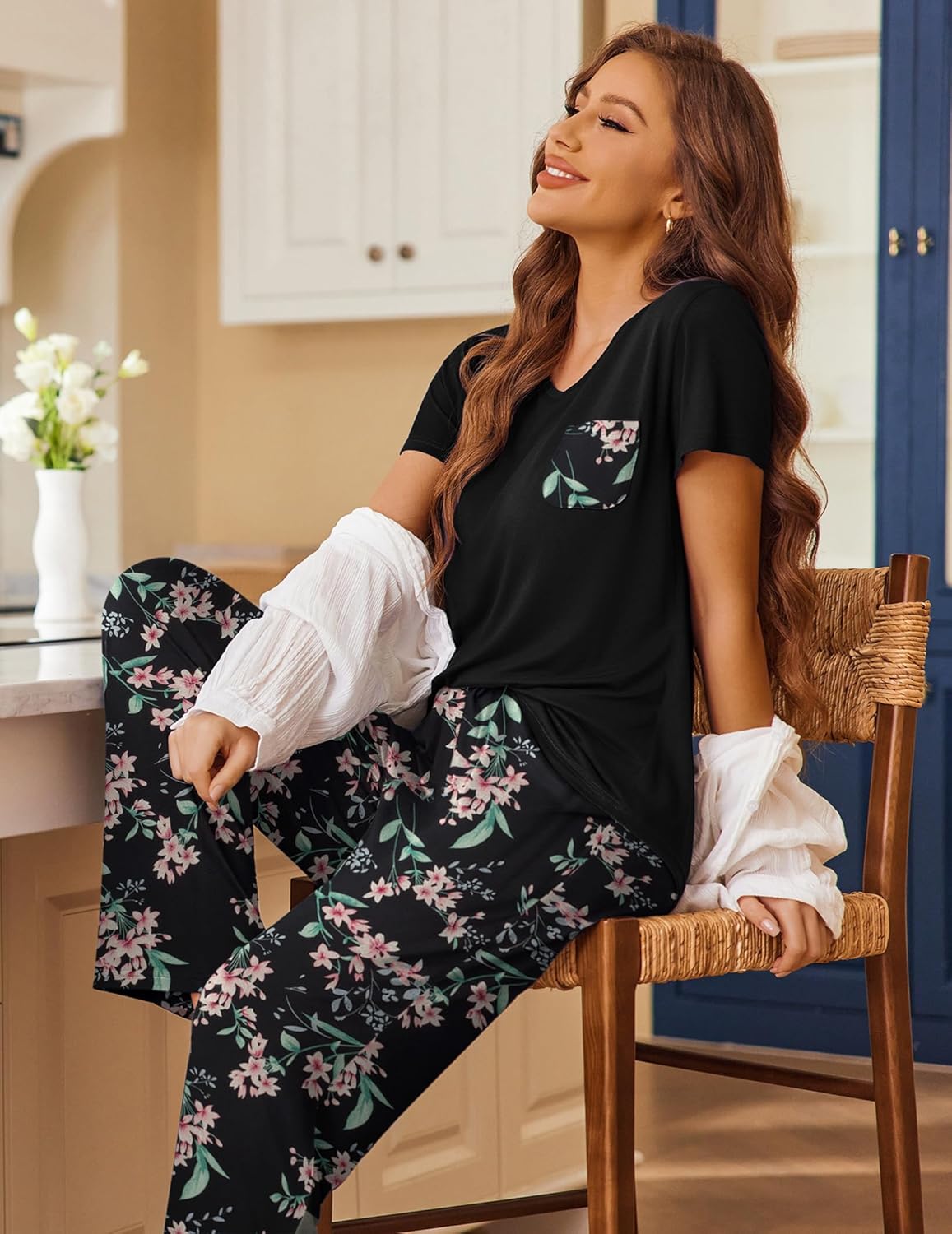 Black pajama set with floral pants, draped top and matching wide legs