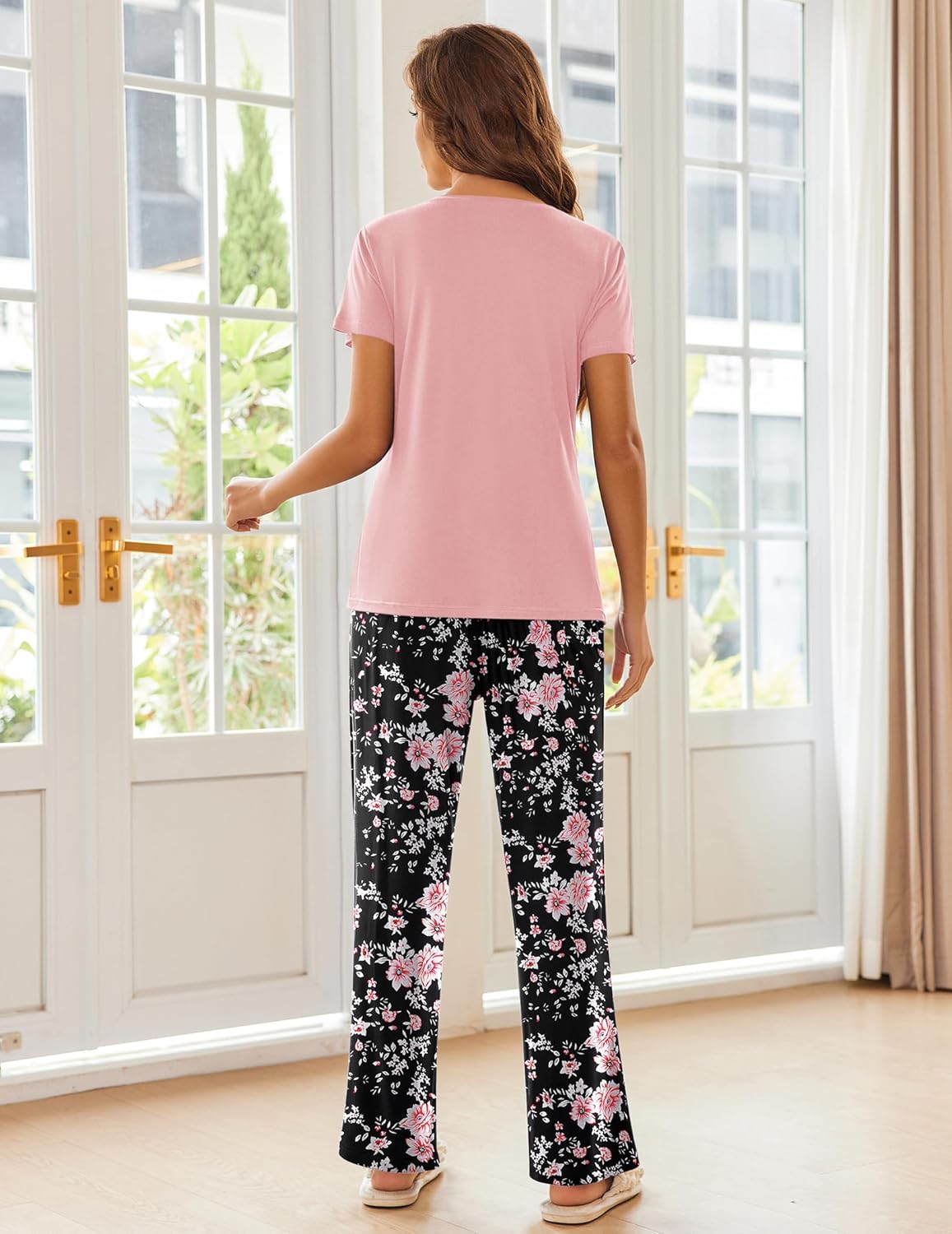 Two-piece pajama set with pink short-sleeve top and black floral wide-leg pants
