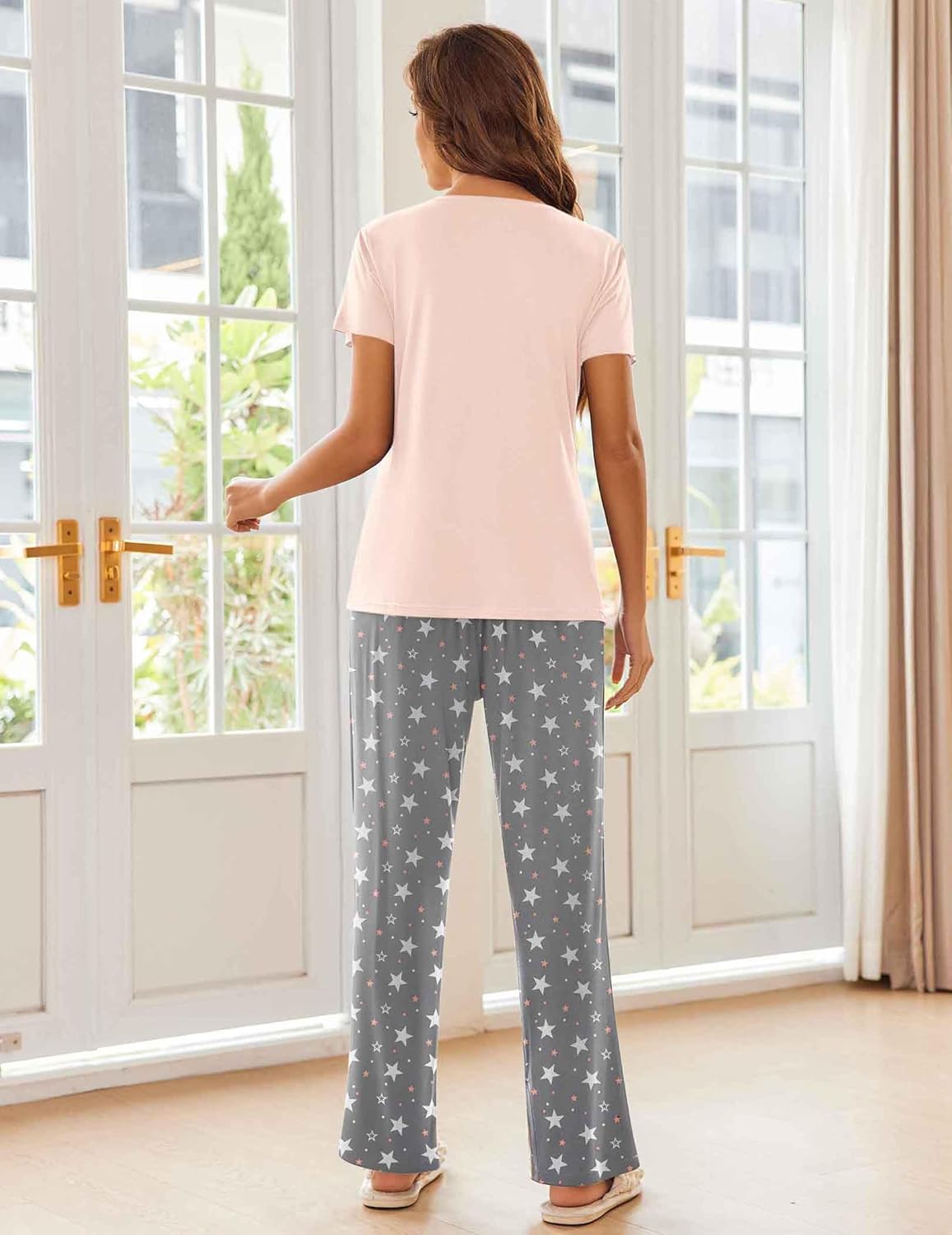 Women's pajama set with pink short-sleeve top and dark gray star pajama pants, back view