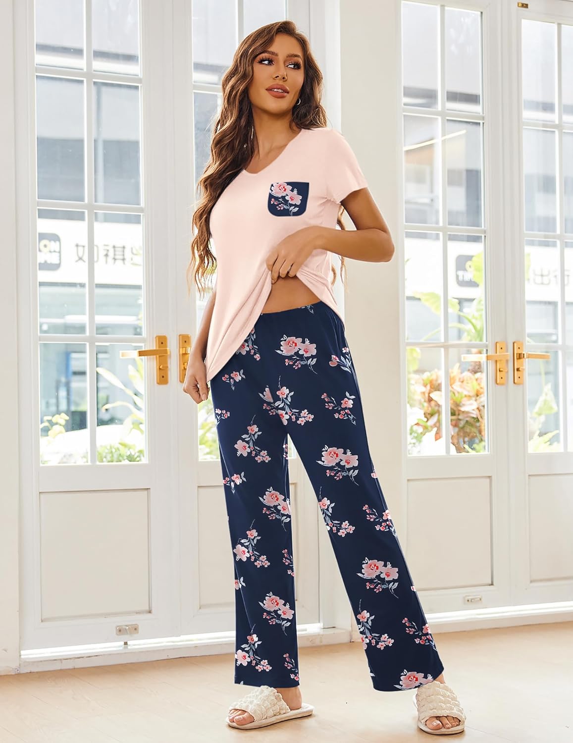 Pink short-sleeve pajama top with floral navy wide-leg pants