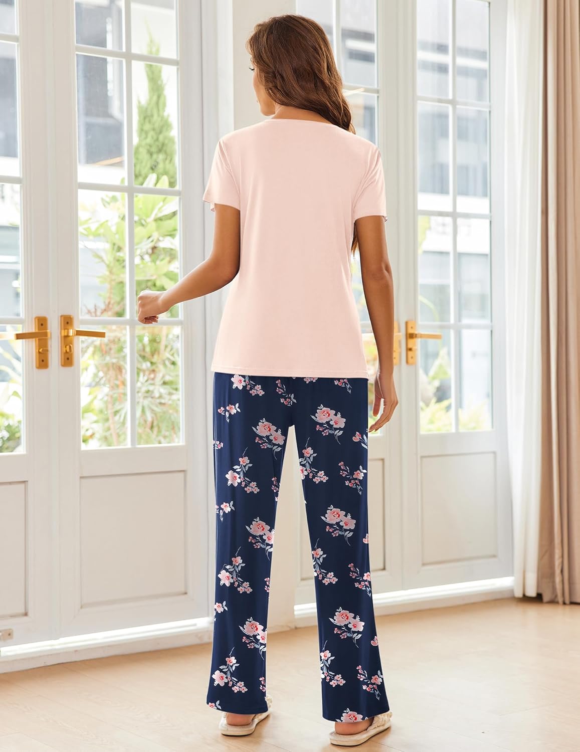 Pink pajama top with navy floral wide-leg pants, back view