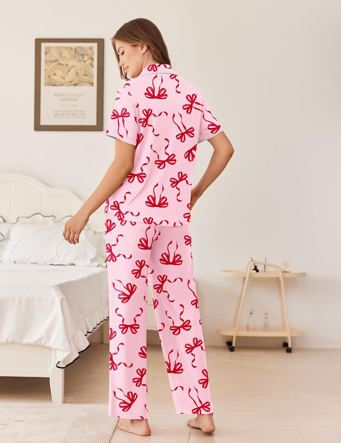 Light pink pajama set with button-front top and long pants, bow print