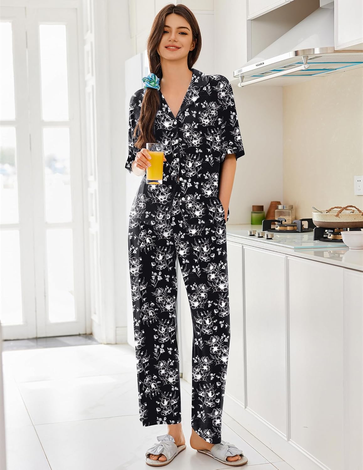 Black pajama set with white floral pattern, short-sleeve button-up top and long pants