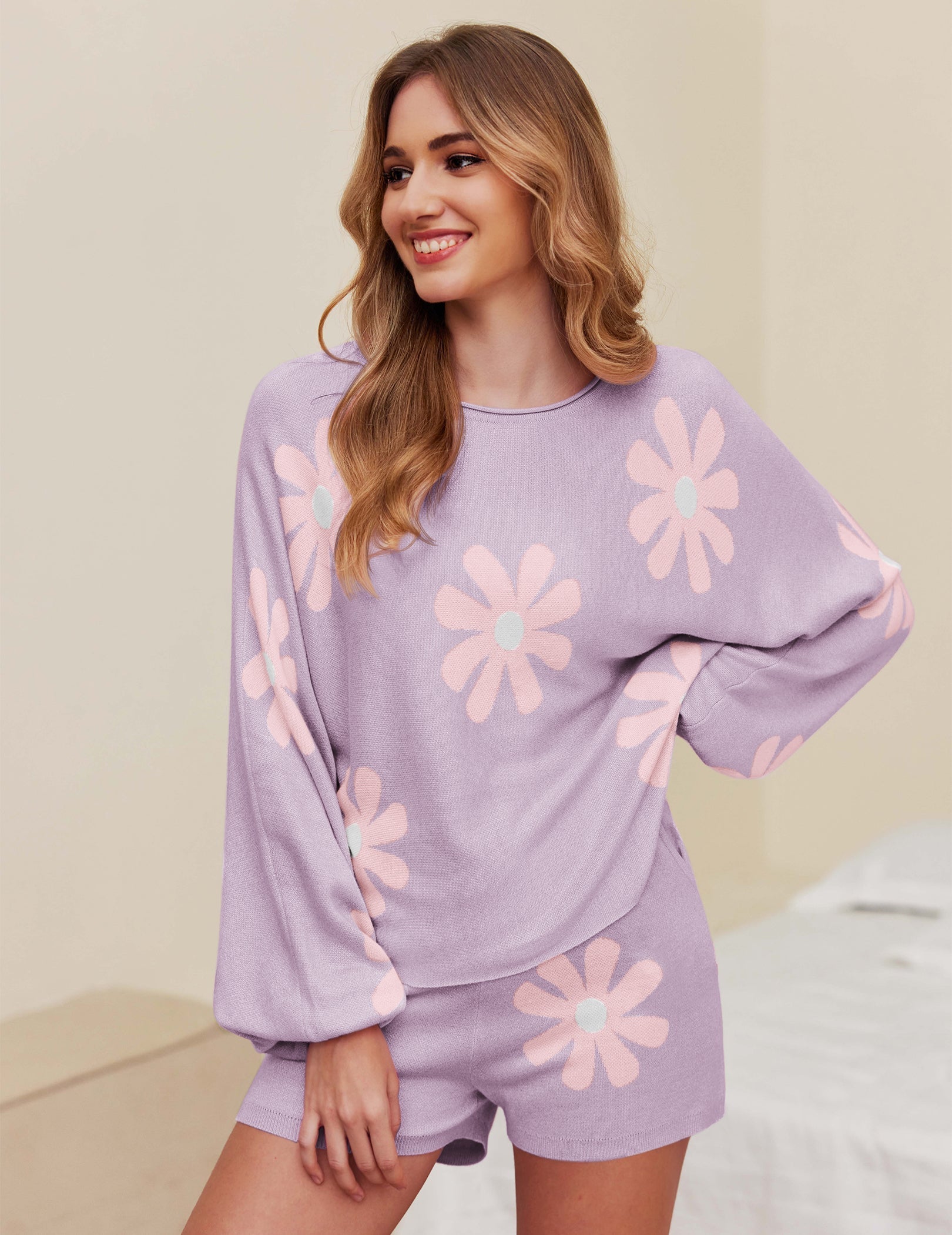 Purple pajama set with white daisy print, long sleeve pullover and matching shorts