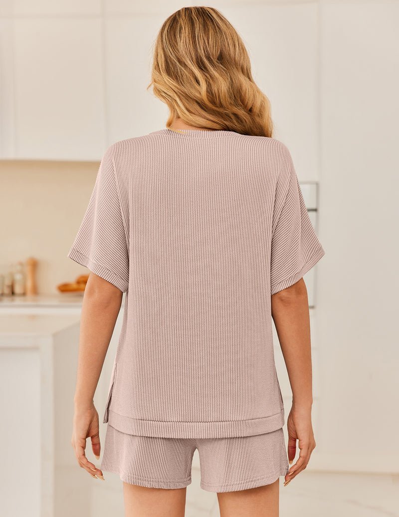 Back view: ribbed 2-piece lounge set with short-sleeve top and shorts, light pink