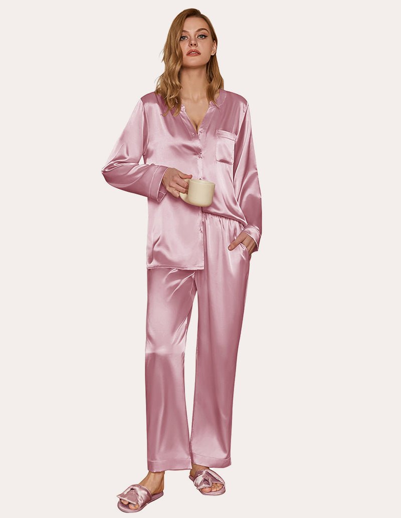 Pink satin pajama set with long sleeves, V-neck style top, and matching wide-leg pants
