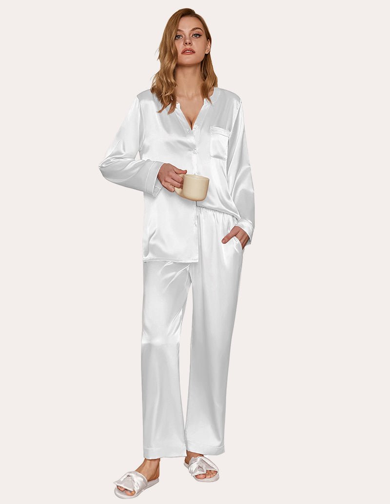 White satin pajama set with long sleeves and button-down top, matching pants