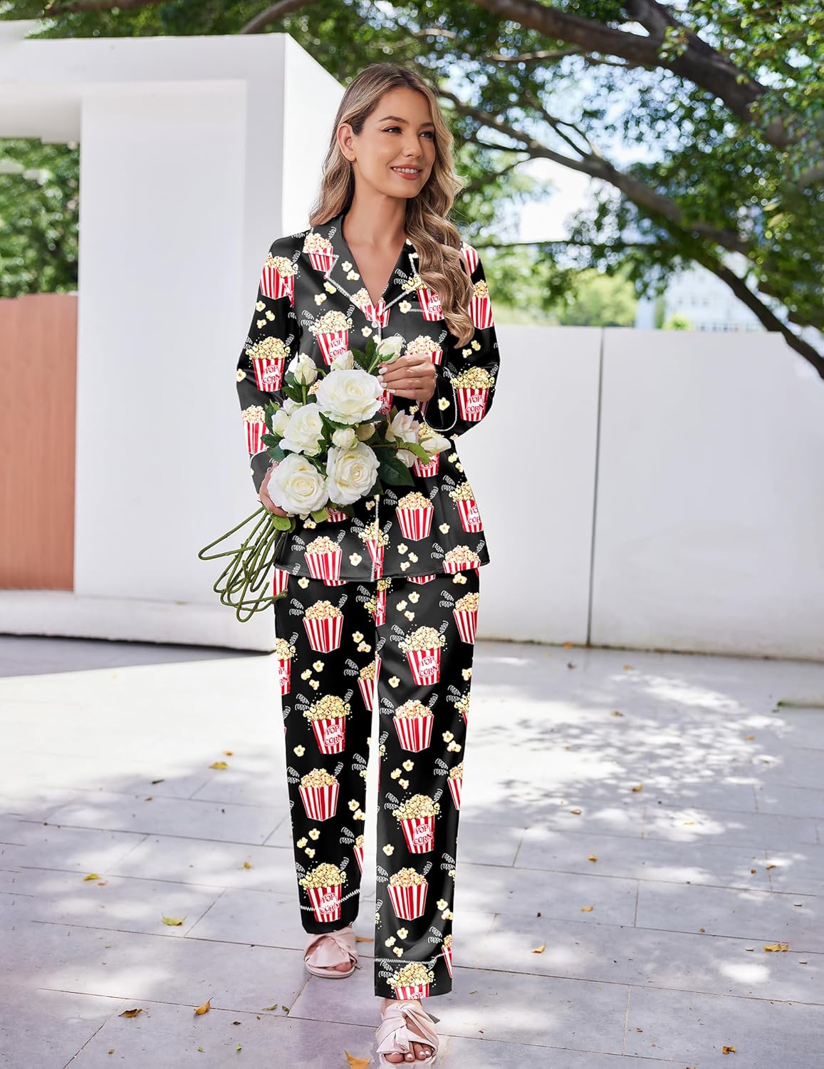 Black Christmas-themed satin pajama set with button-front top and matching long pants