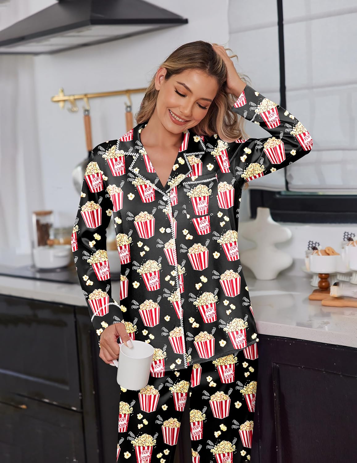 Black satin pajama set with colorful popcorn-and-drink print, button-front top