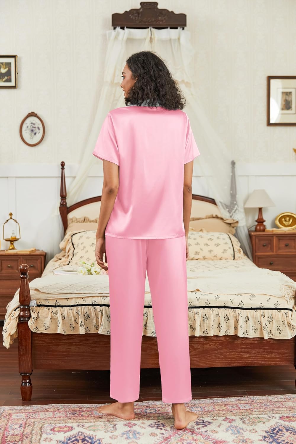 Pink satin pajama set with short-sleeve button top and matching wide-leg pants, back view