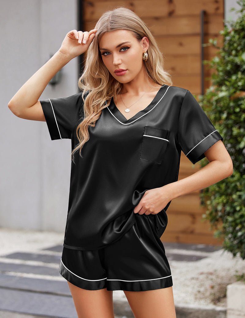 Black satin short-sleeve pajama set with white piping and matching shorts