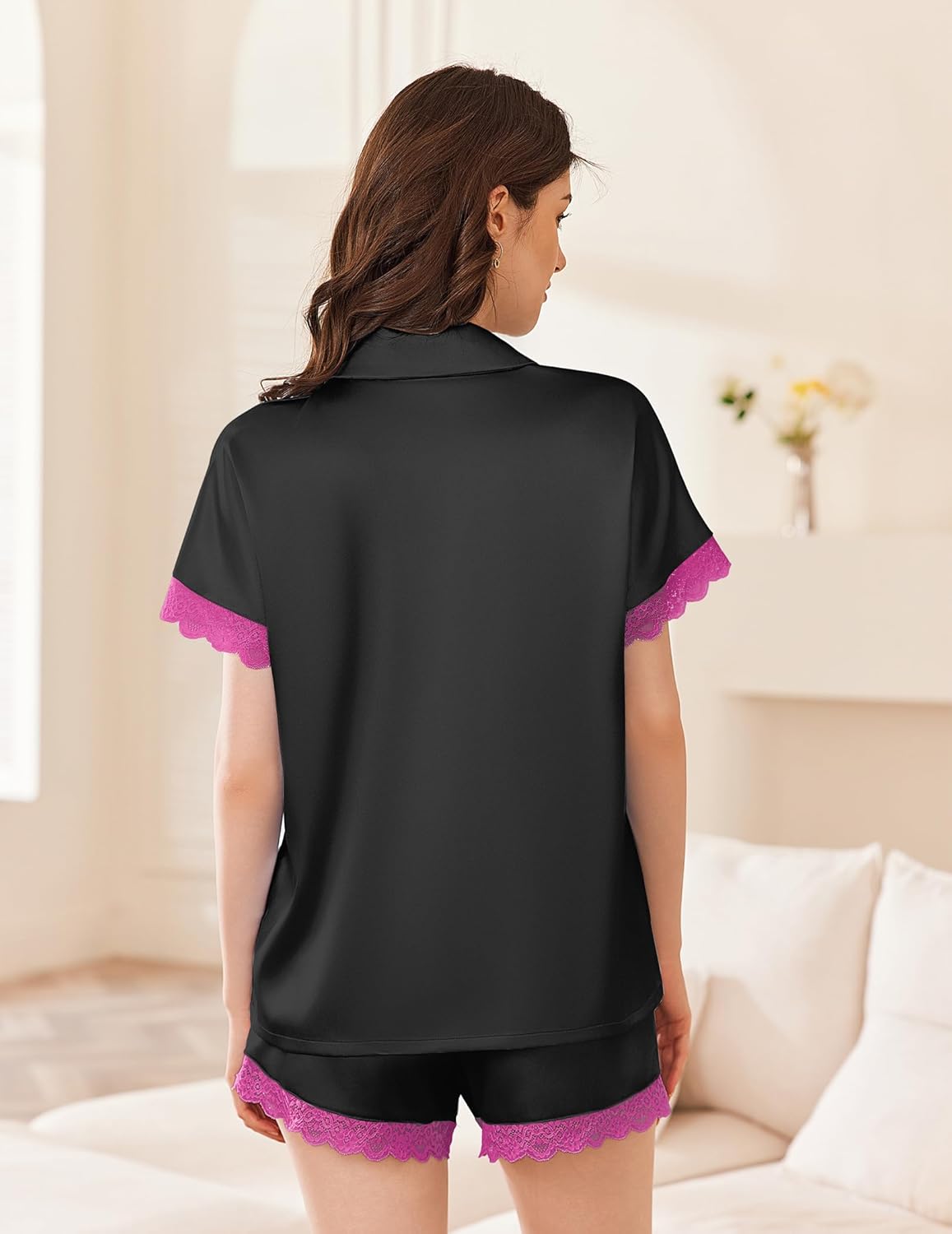 Black satin pajama set with pink lace-trimmed short sleeves and lace hem shorts