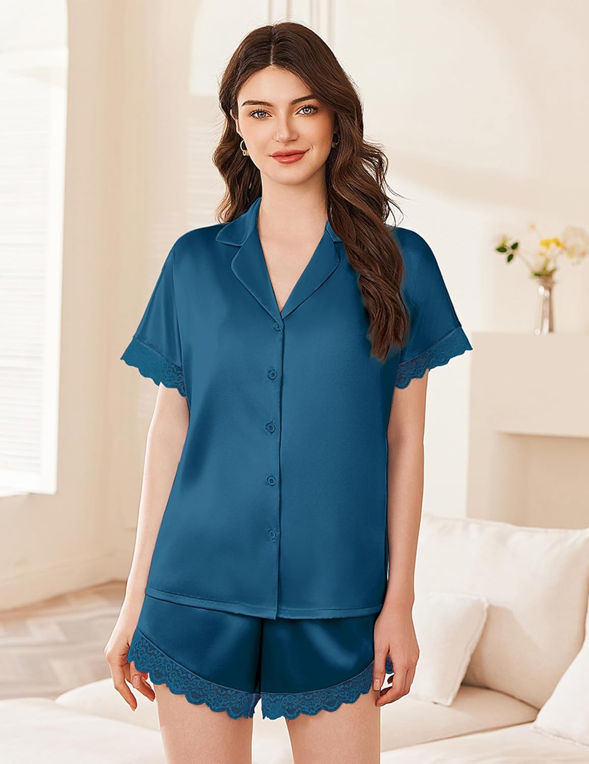 Blue satin pajama set with button-front short-sleeve top and lace-trimmed shorts