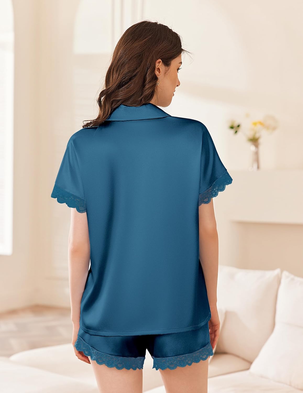 Blue satin pajama set with V-neck button top and lace-trim shorts, scalloped hem