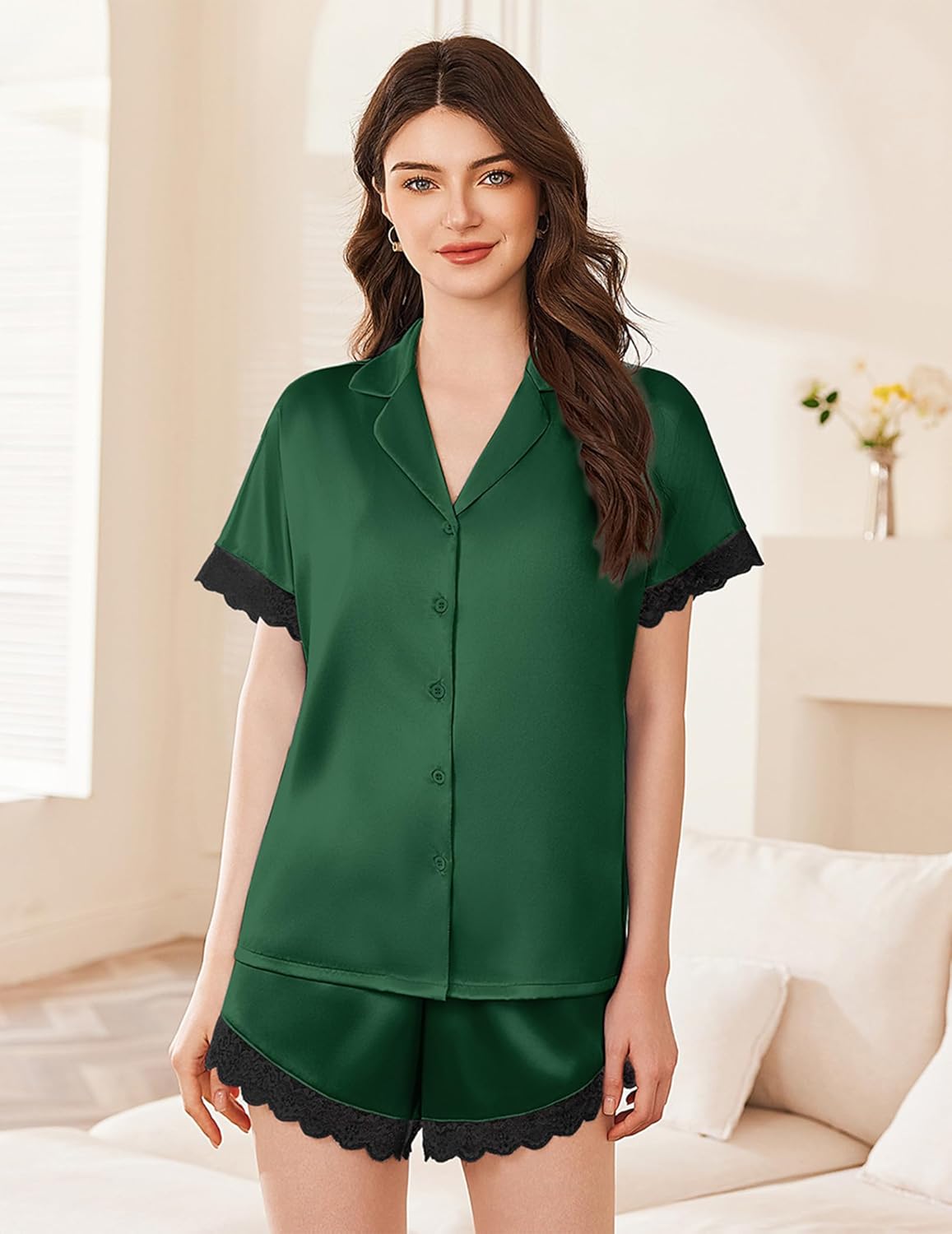 Green satin pajama set with button-front short-sleeve top and lace-trim shorts