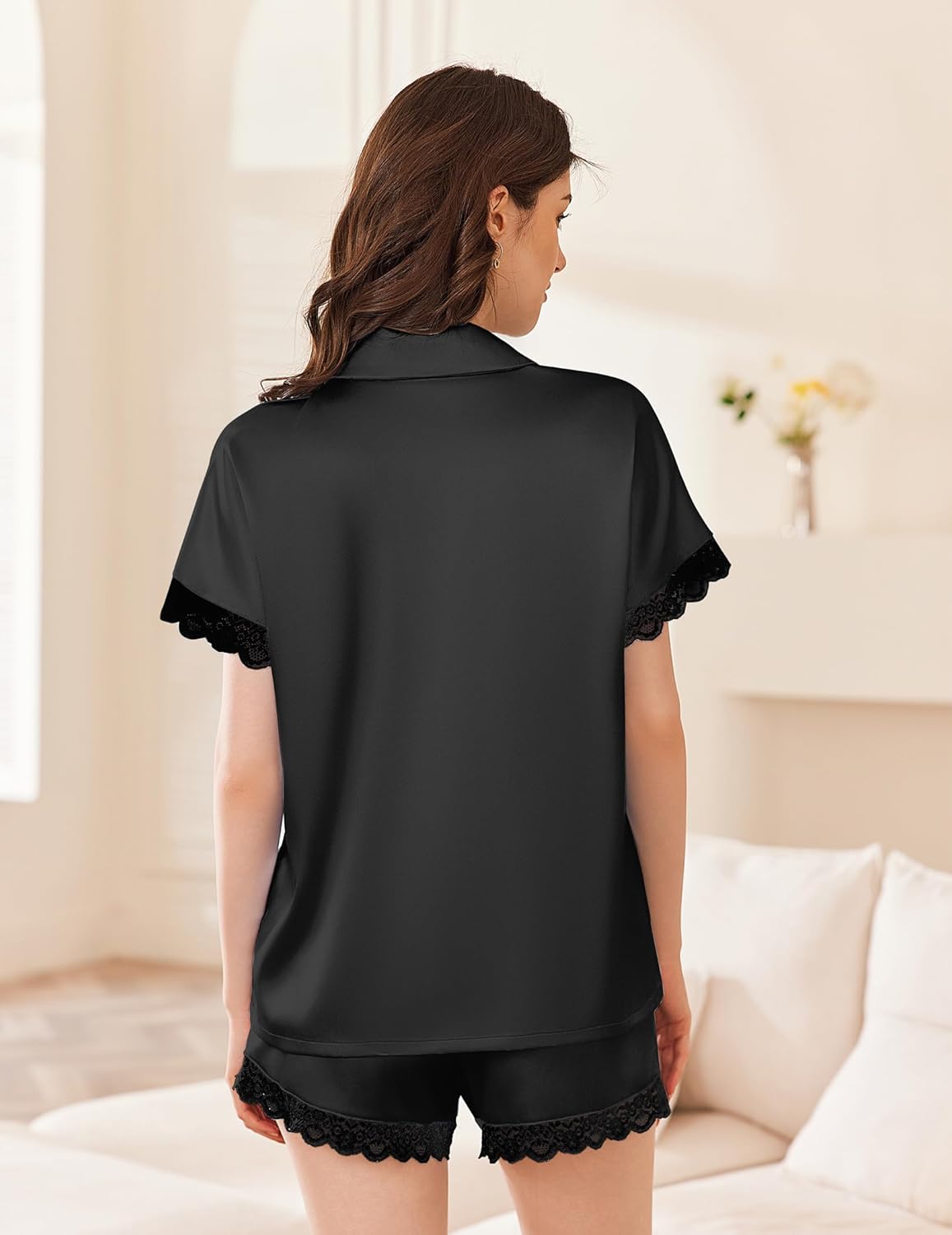 Black satin pajama set with short-sleeve button top and lace-trim shorts, back view