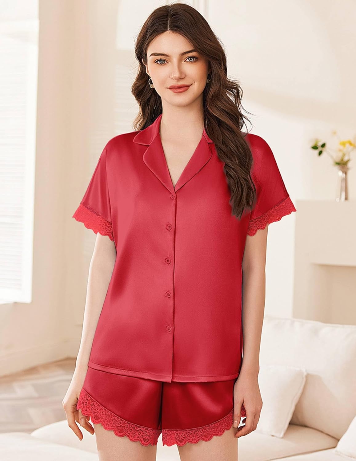 Red satin pajama set with short-sleeve button-up top and lace hem shorts