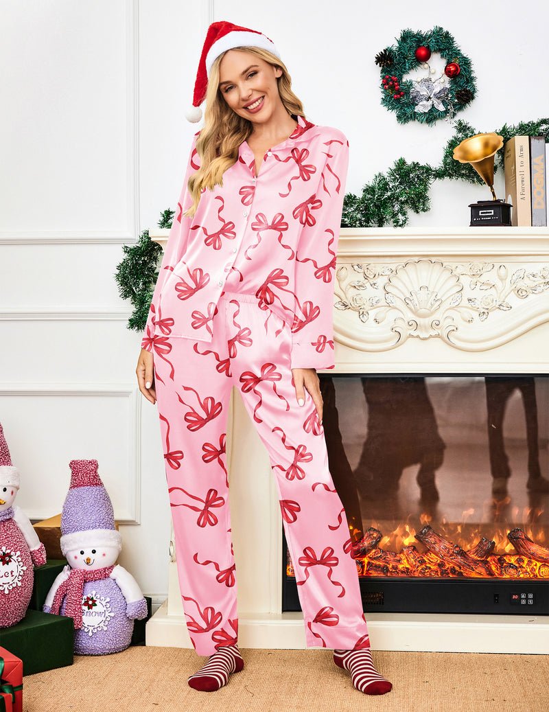 Pink bow-print silk pajama set with long sleeves and straight-leg pants, festive hat look