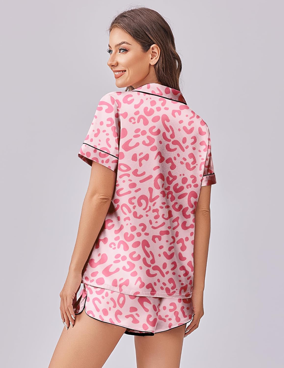Pink leopard print satin pajama set with button-front top and matching shorts