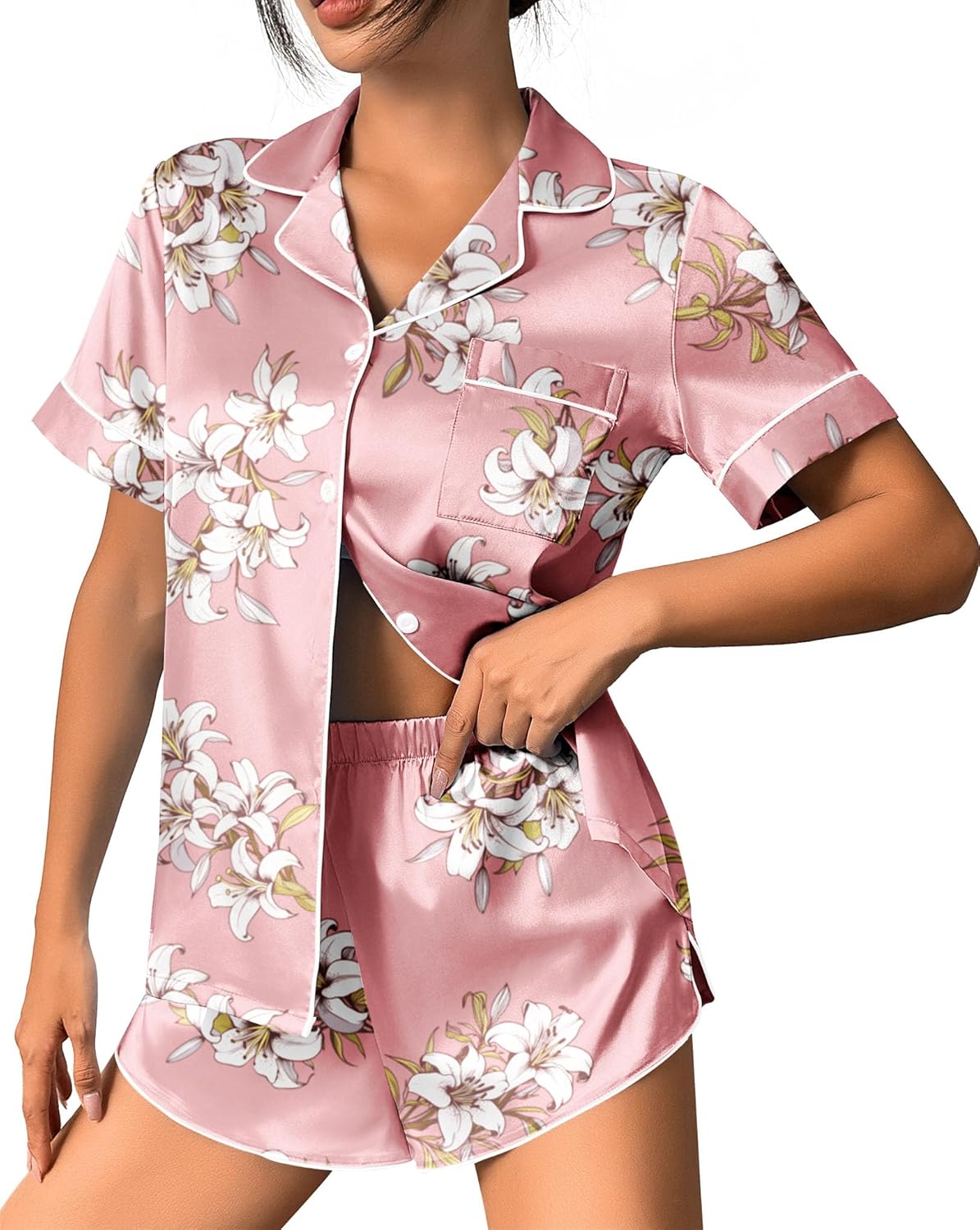 Pink satin pajama set with white floral print, button-up top and matching shorts