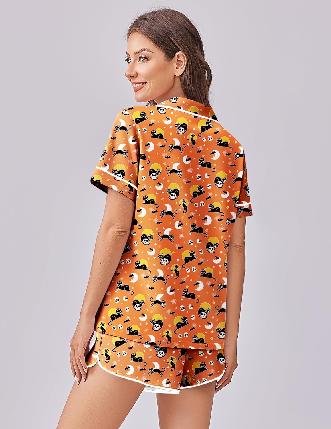 Back view: orange Halloween skull cat print pajama set with matching shorts