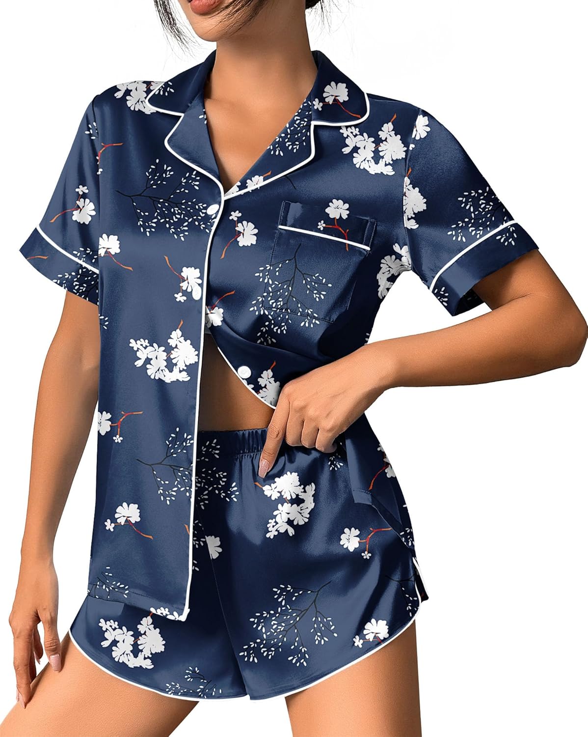 Navy satin pajama set with white floral print, button-up short-sleeve top and shorts