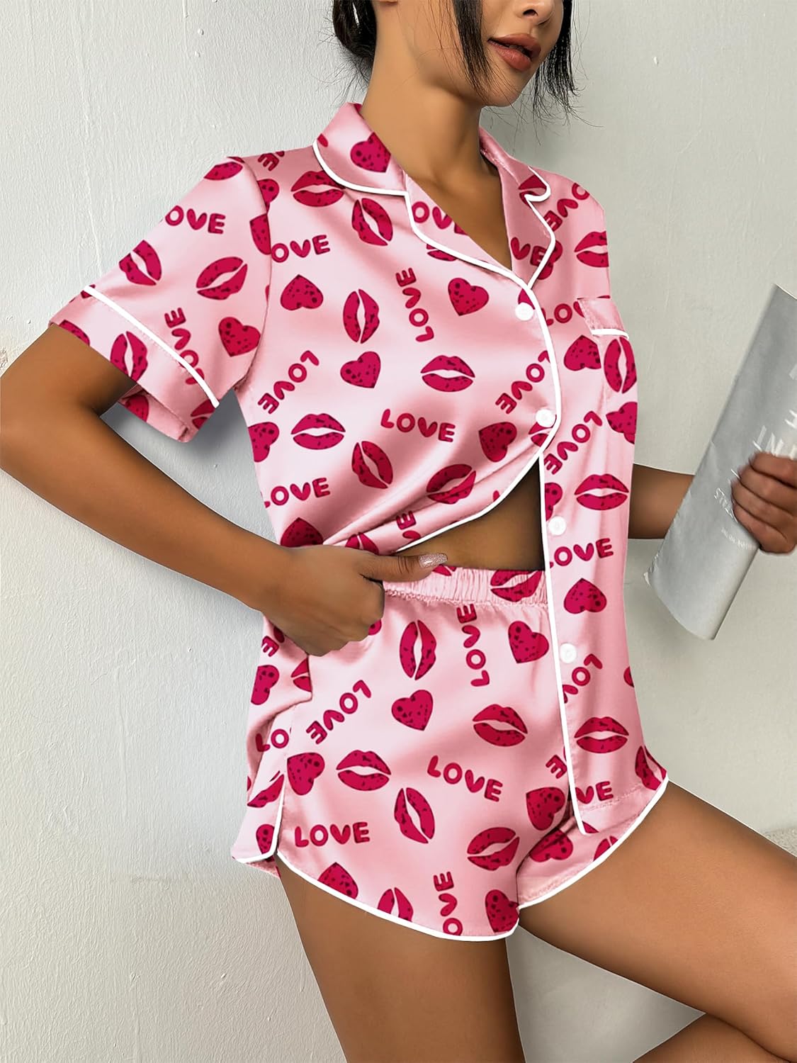 Pink satin pajama set, short-sleeve button top with heart-and-lip print and elastic shorts
