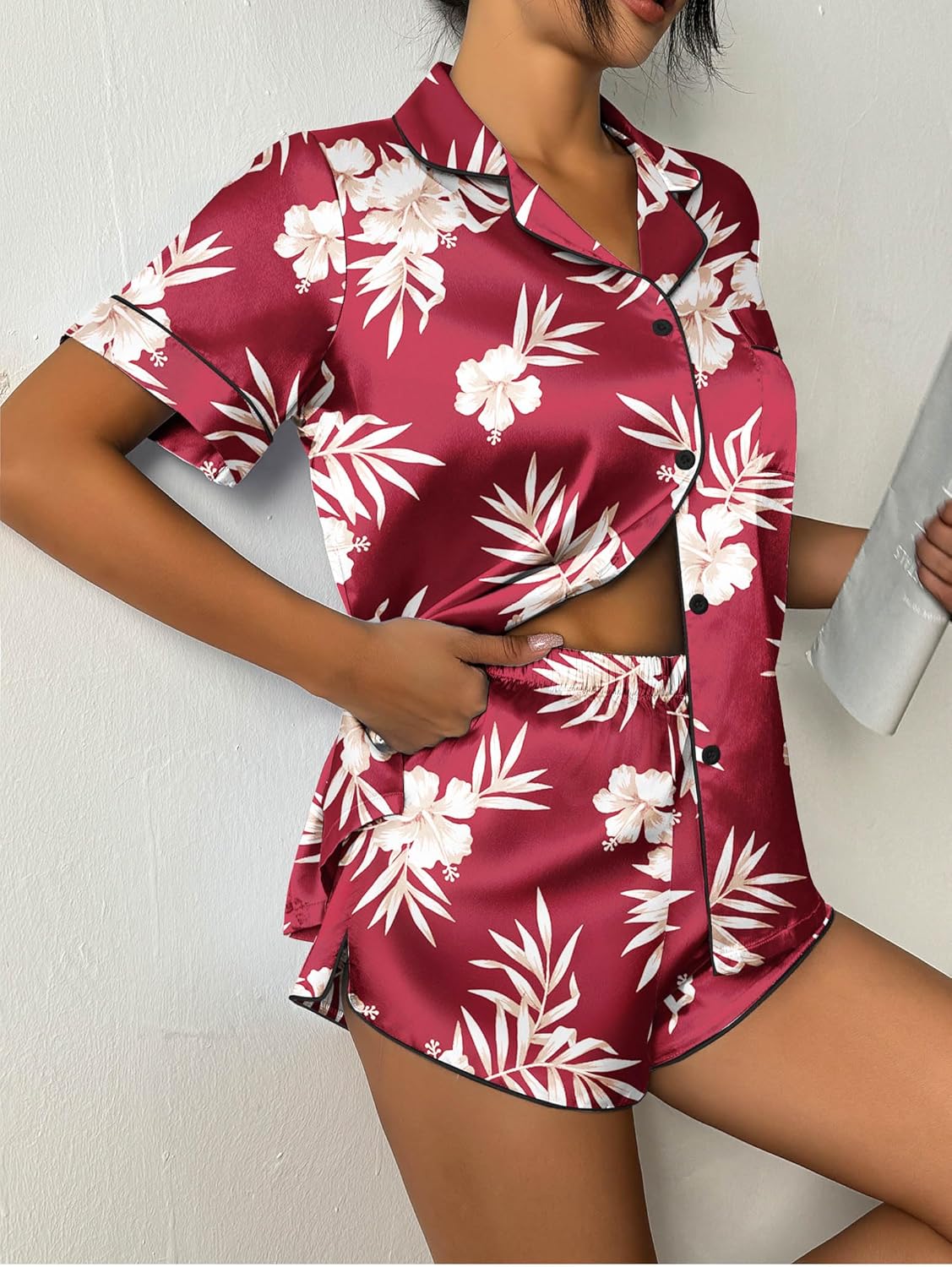Burgundy satin pajama set with white floral and leaf print, button-up top and shorts
