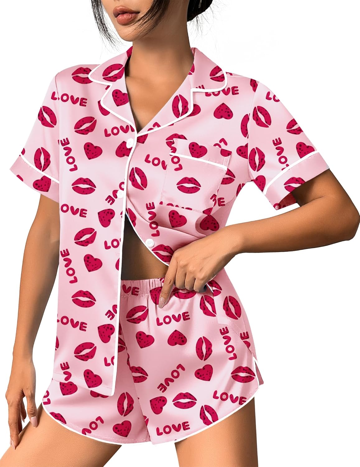 Pink satin pajama set with heart-and-lip print button-up top and matching shorts