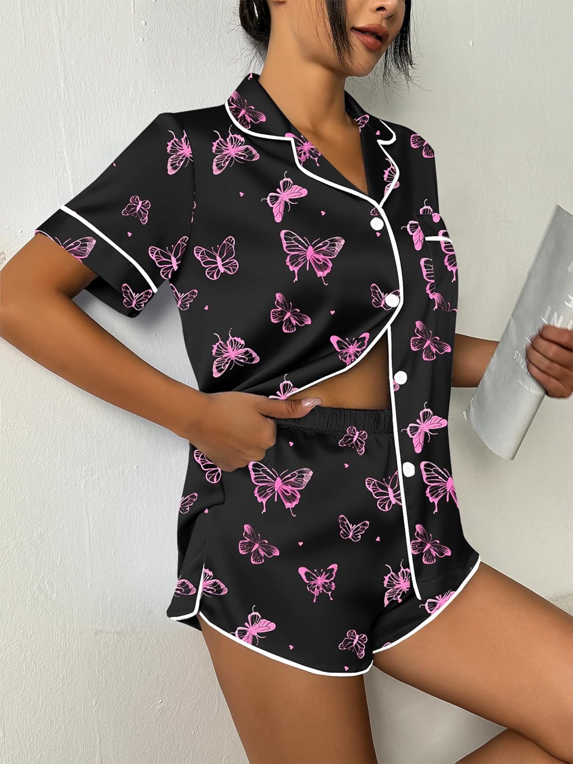 Close view butterfly-print pajama set: short-sleeve button top with curved piping and shorts