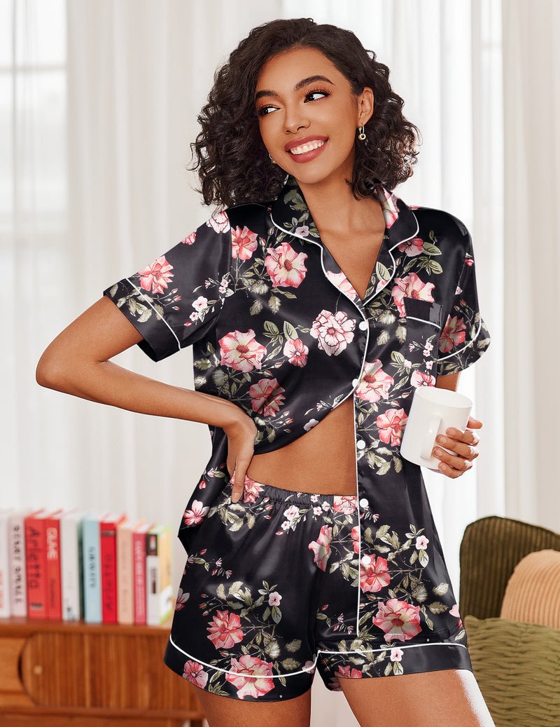 Black pajama set with pink floral print, short sleeves, button-up top and matching shorts