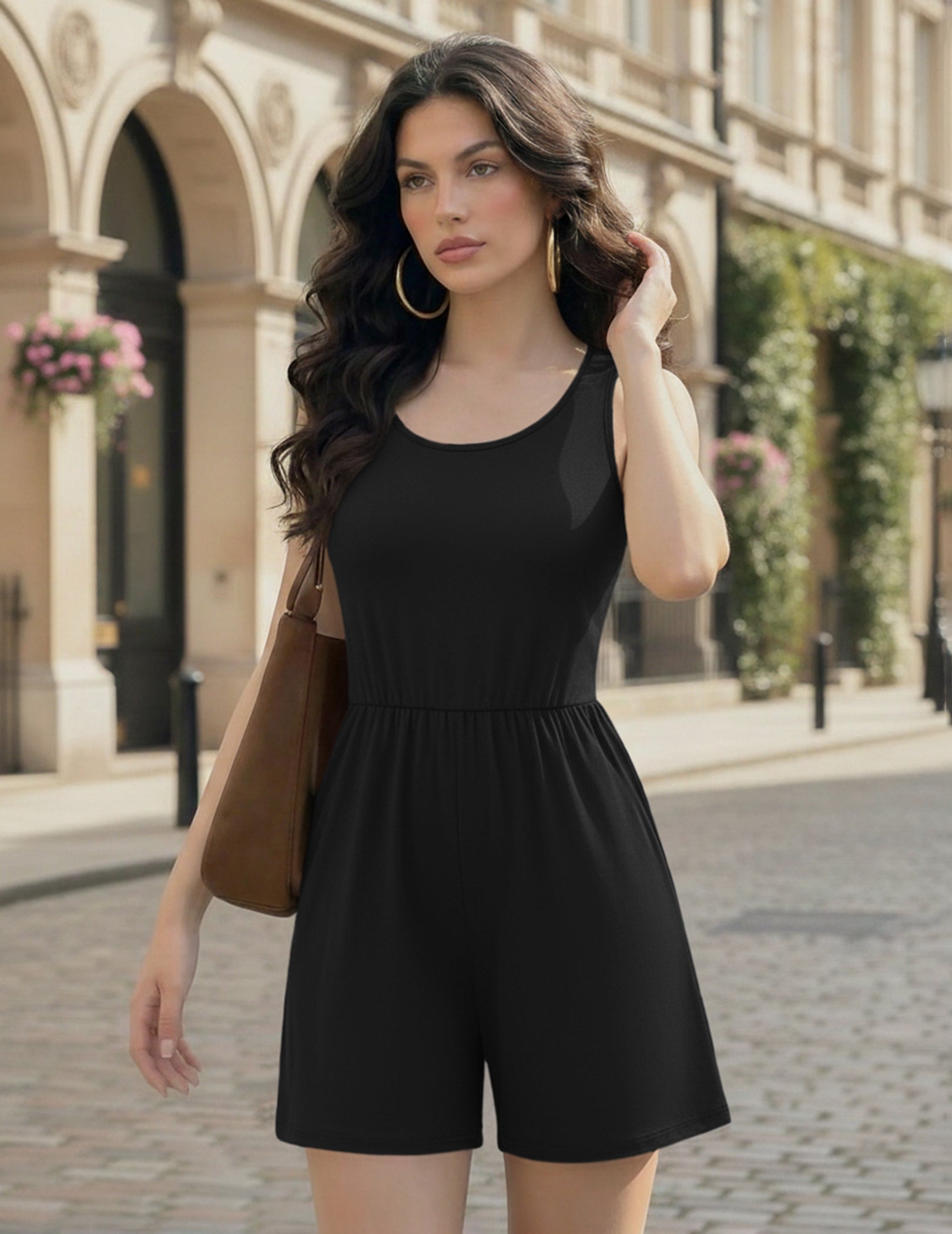 Black sleeveless romper with scoop neckline and relaxed short pant legs