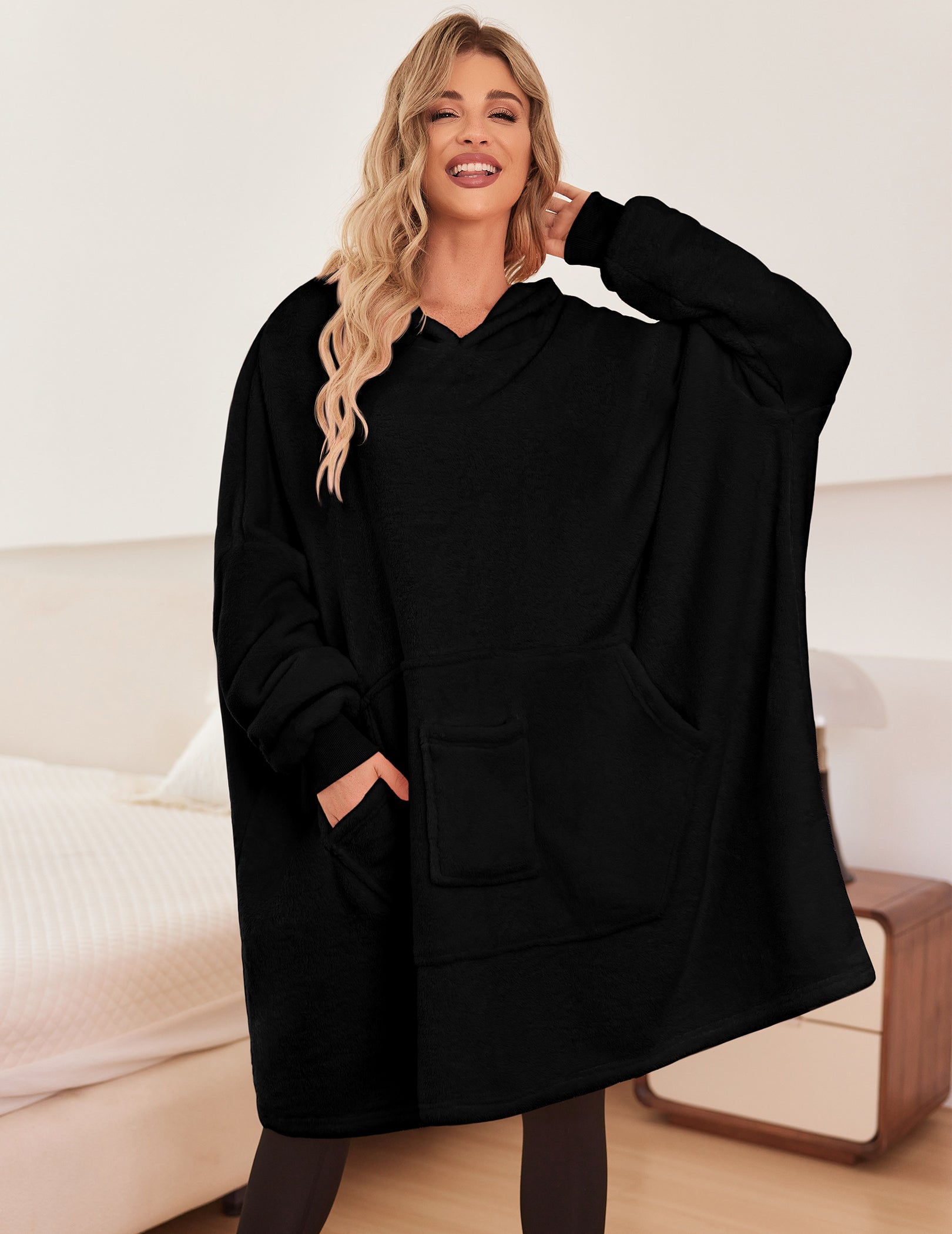 Black oversized hooded bathrobe with front pouch pockets and long sleeves