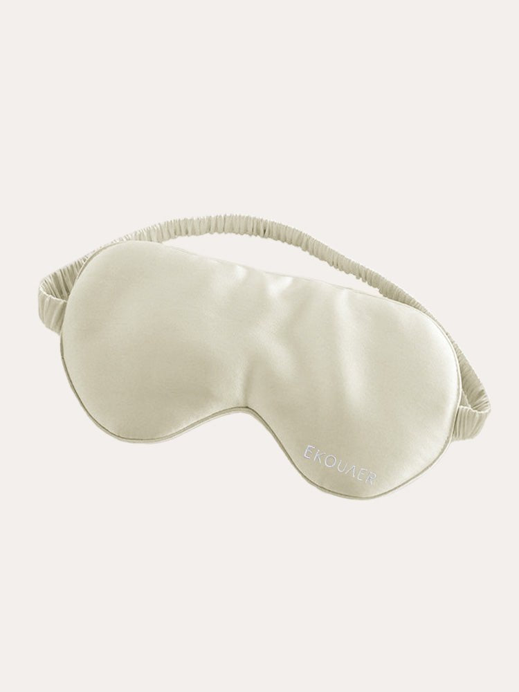 Cream satin sleep eye mask with curved eye shape and elastic strap