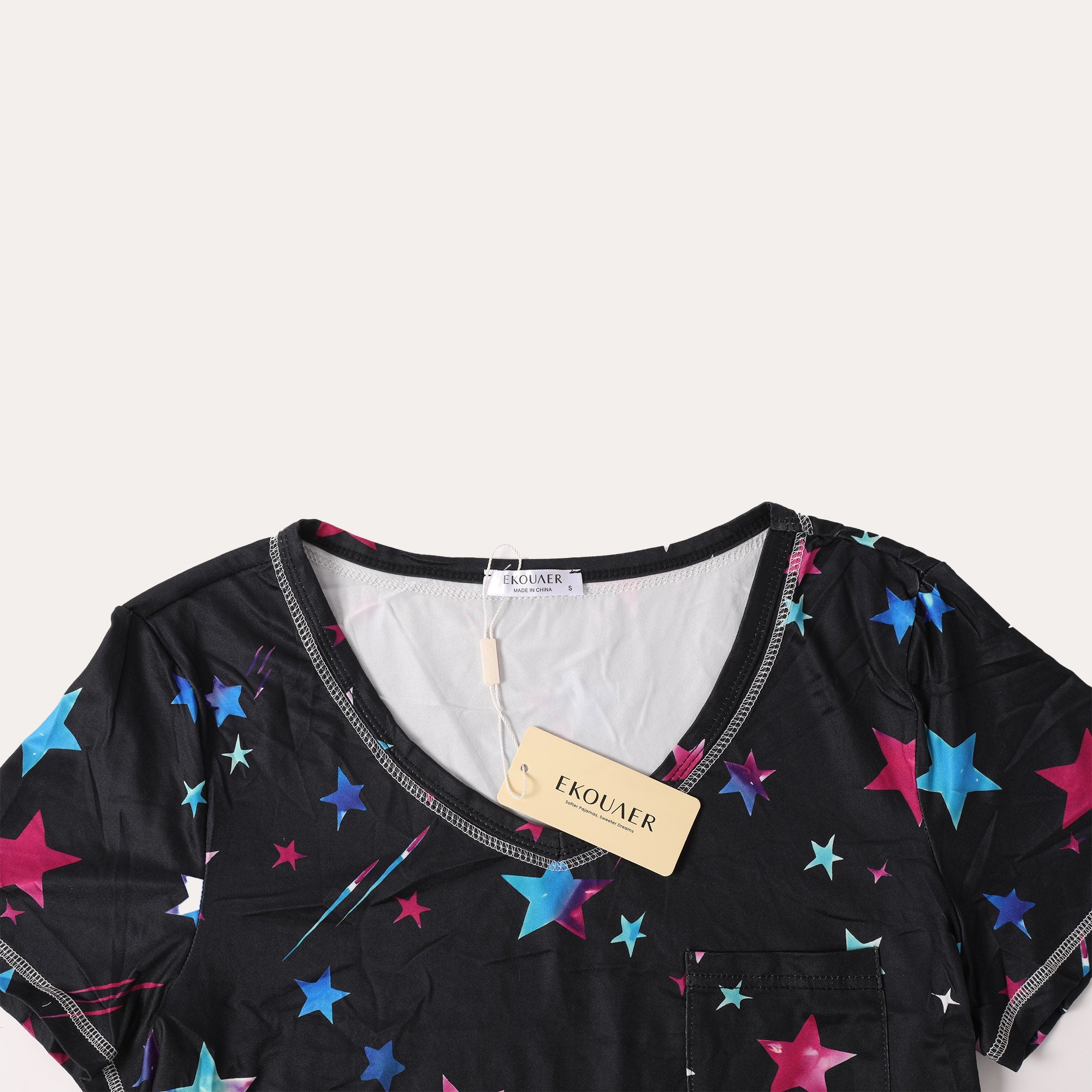 Black star-print T-shirt close-up with multicolor stars and V-neck trim