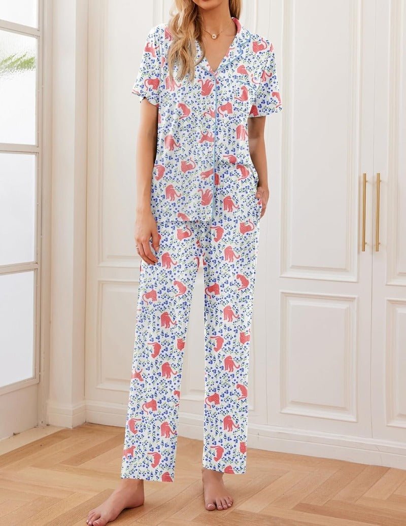 White pajama set with colorful animal print short-sleeve button-front top and long pants