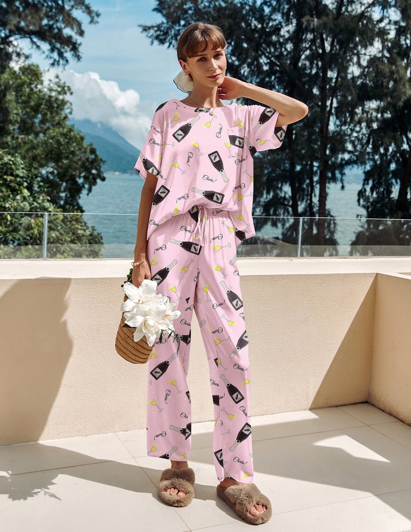 Light pink satin pajama set with patterned bows, short-sleeve top and matching long pants