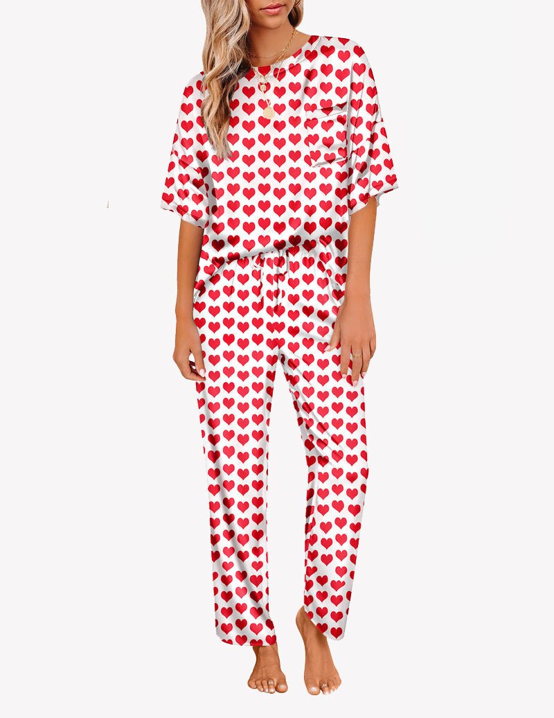 White satin pajama set with red heart print, short-sleeve top and long tapered pants