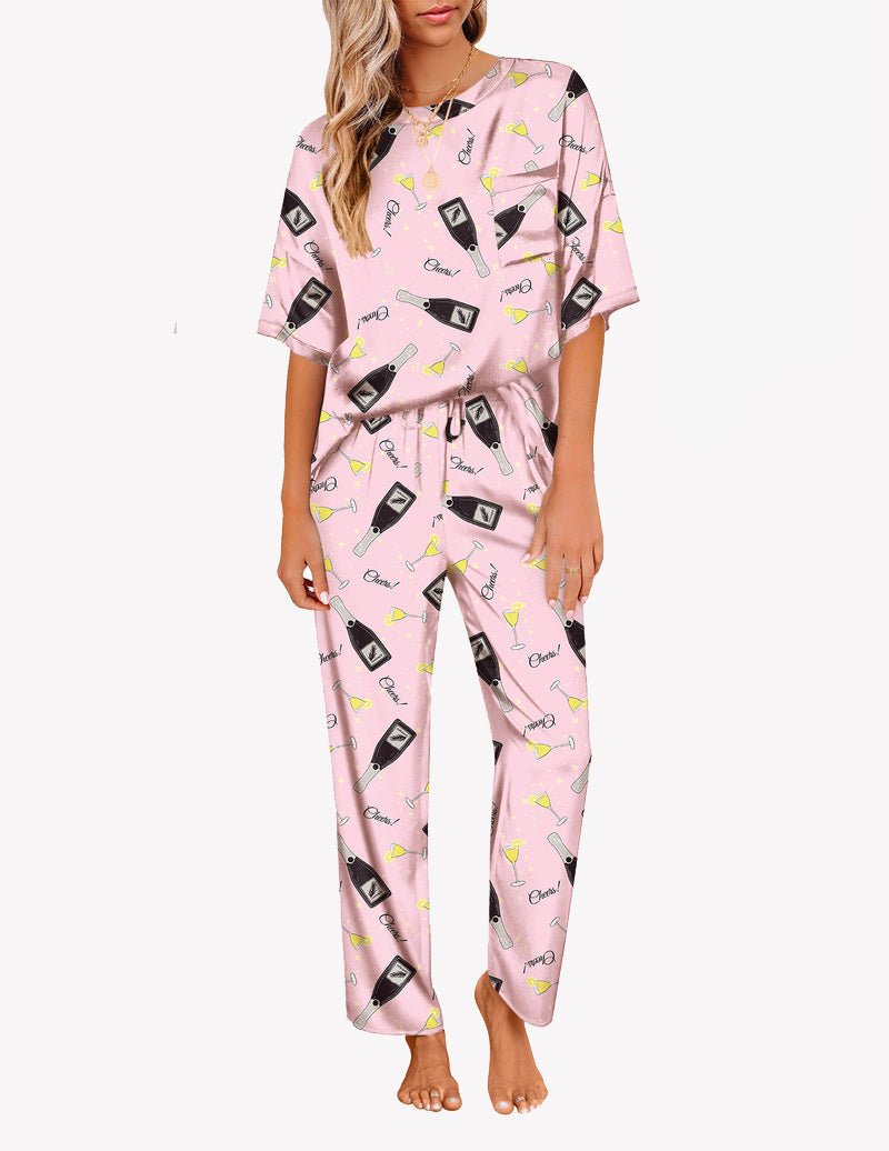 Pink satin pajama set with small utensil-and-cat print, short-sleeve top and long pants