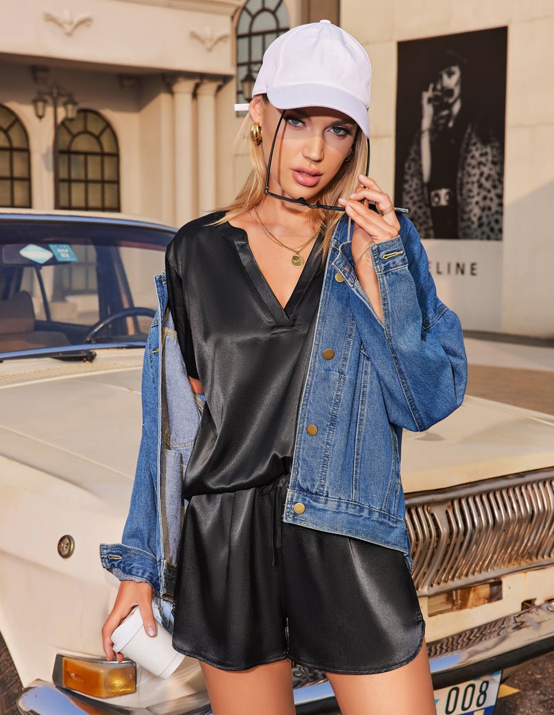 Black satin pajama set with V-neck top, short sleeves, and drawstring shorts