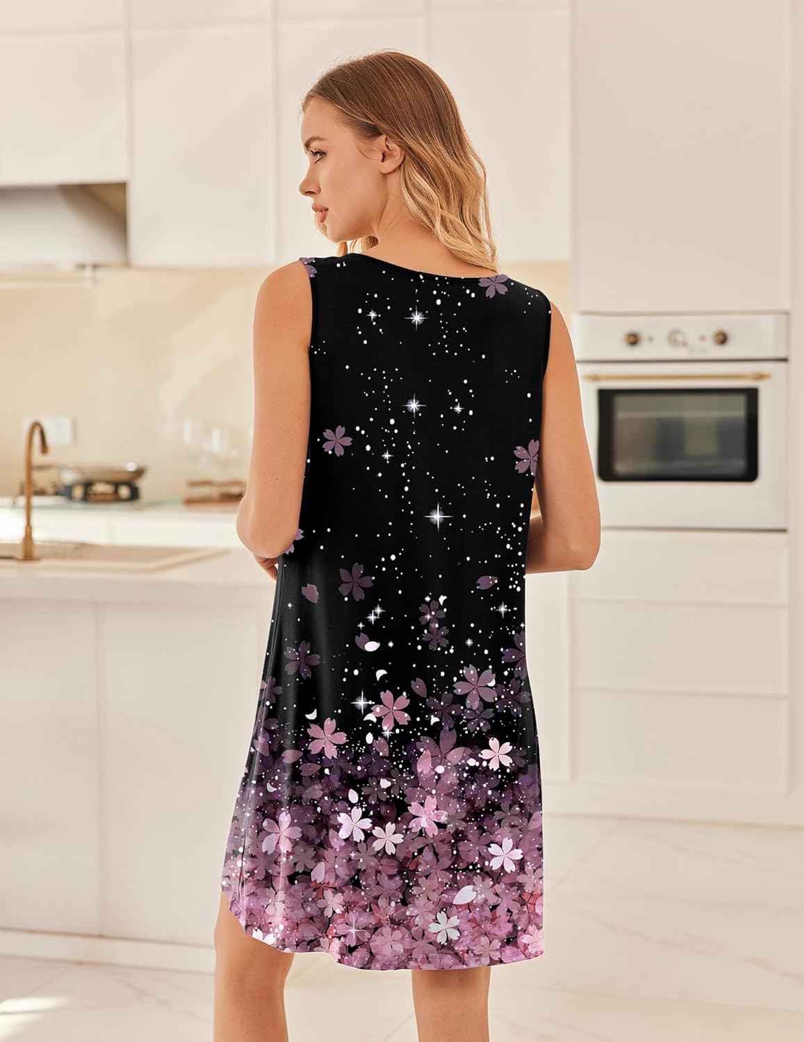 Back view of black sleeveless night gown with purple floral and star sparkle print