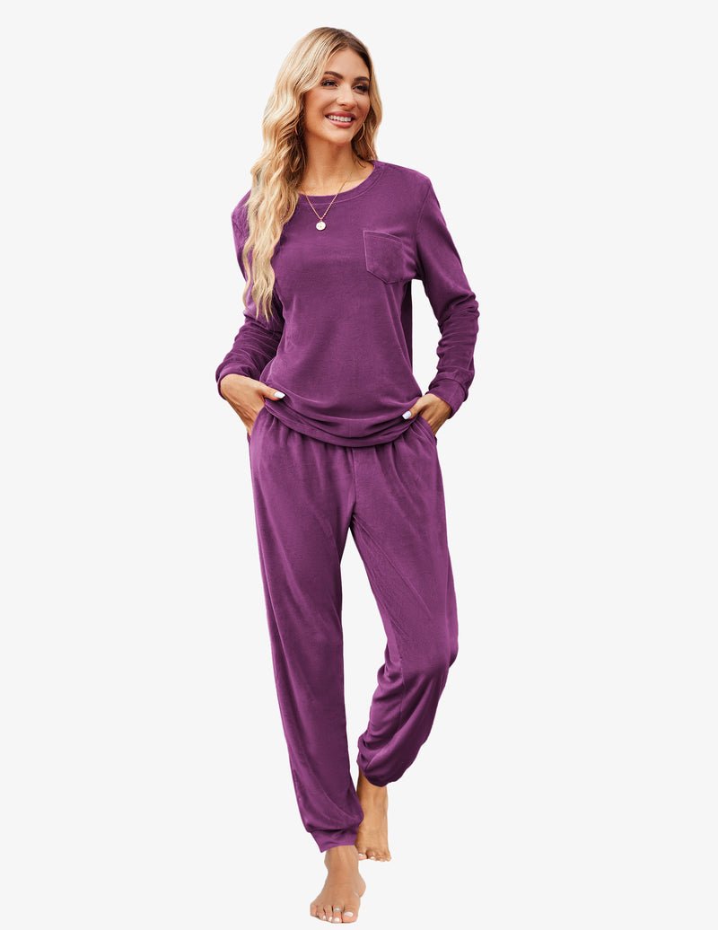 Purple velour tracksuit set with long sleeves, chest pocket, and cuffed jogger pants.